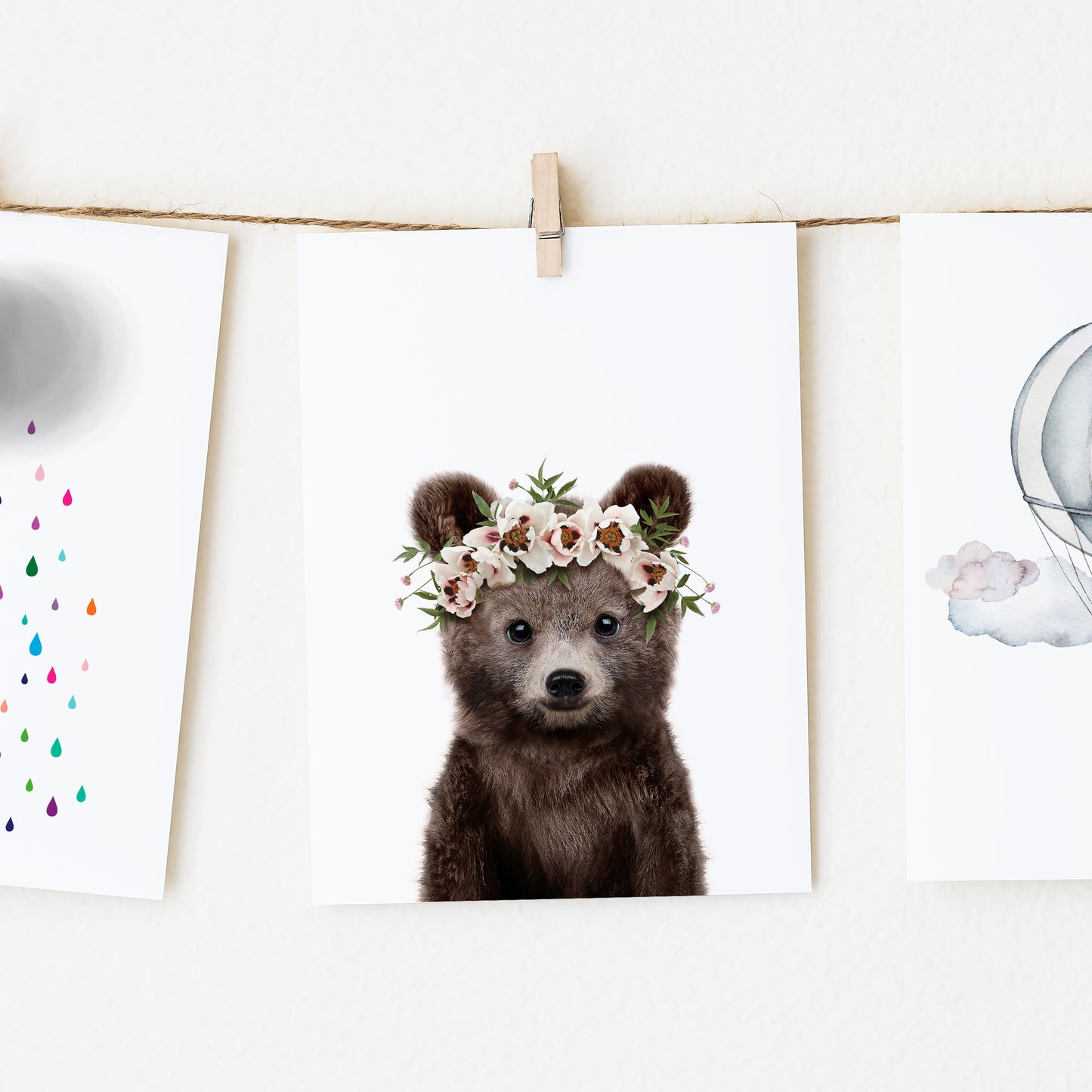 A picture of a baby bear wearing a flower crown.
