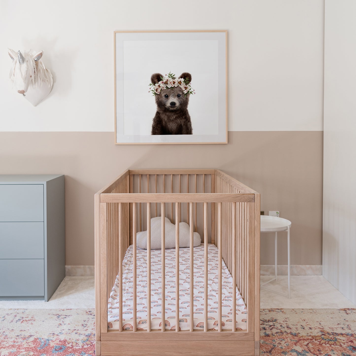 A picture of a baby bear wearing a flower crown in a girls nursery