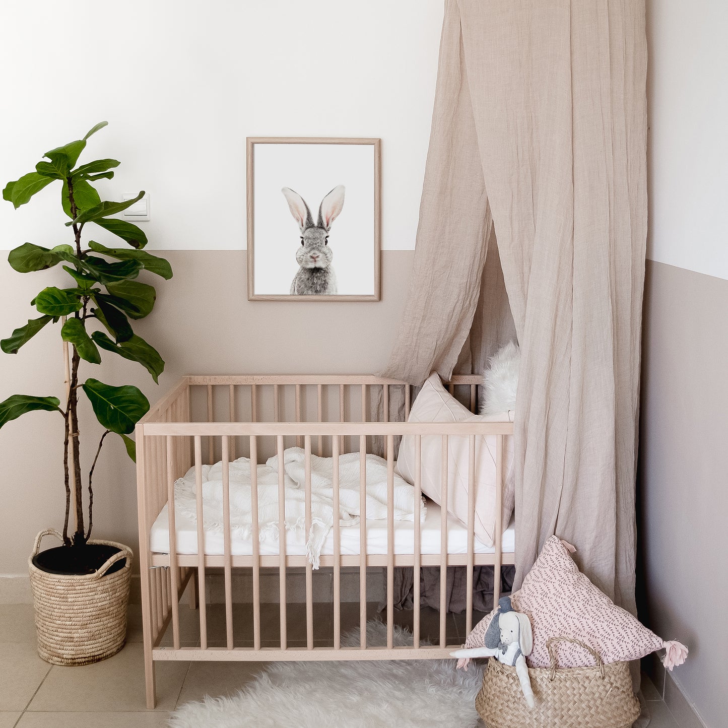baby bunny art print in a blush woodland nursery above the crib 