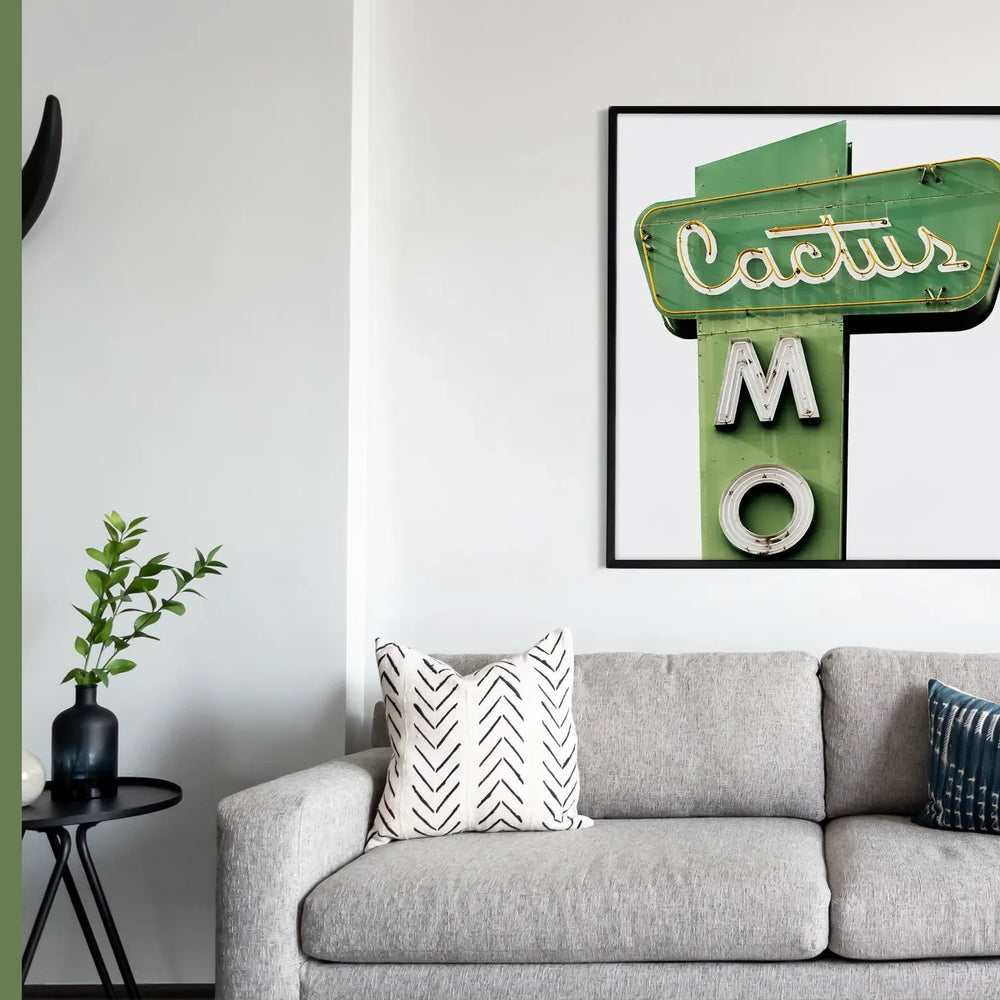 fine art print of cactus framed above couch 